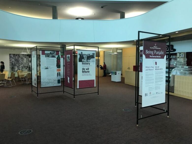 Several exhibit panels stand in an open area inside a building.