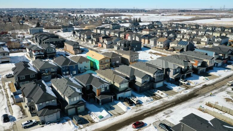 Homes and suburban streets are seen from the air.