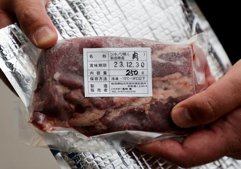 A close-up of bear meat in a plastic package.