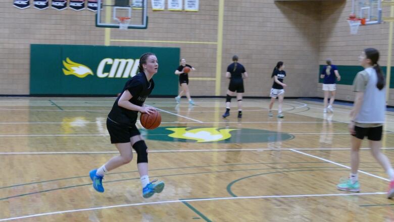 Abby Sweeny gets ready to take a shot during her basketball practice with the Evolve Basketball Club.