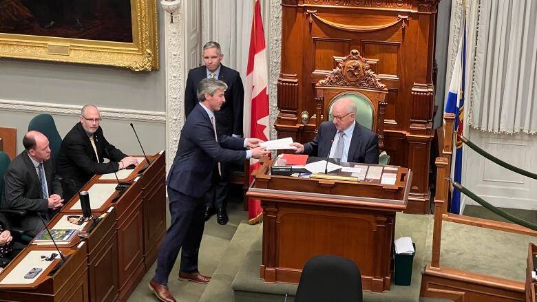 Nova Scotia Premier Tim Houston hands the 2023-24 provincial budget to Lt._Gov. Arthur Leblanc in the legislature on April 12, 2023.