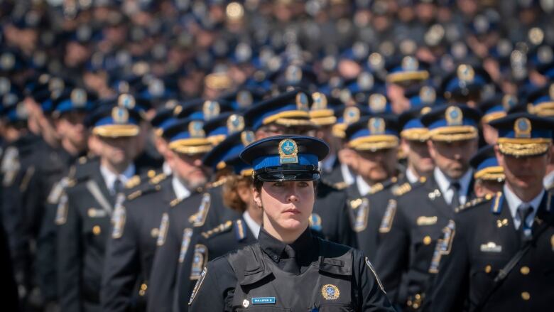 Wall of police officers in blue and black.