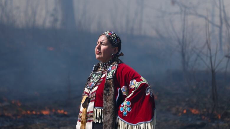 Jingle dress dancers participate in a ceremony at prescribed burn at High Park