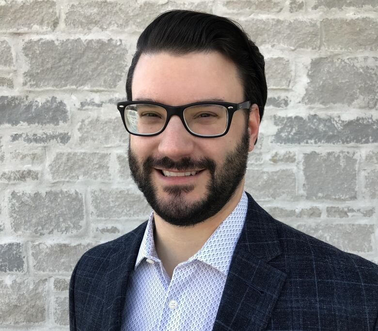 Jason Jaskolka smiles at the camera in a professional headshot.