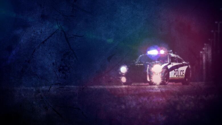 A police cruiser, with its lights flashing, is pictured in the distance in this photo illustration.