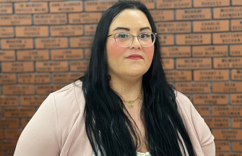 A woman with glasses and long hair.