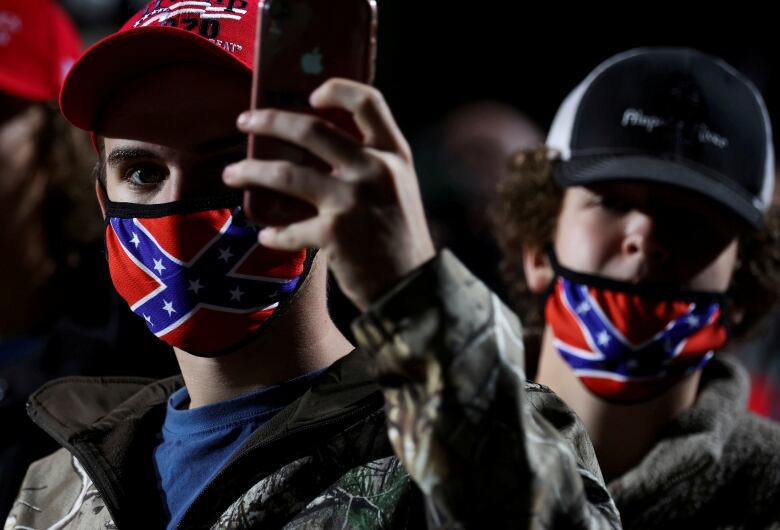 Men in cofederate flag face masks 