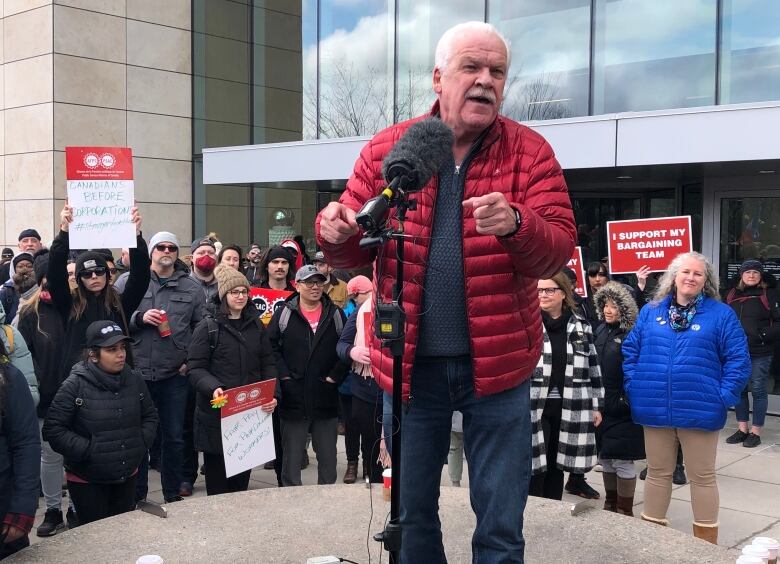 A man speaks with a bullhorn.