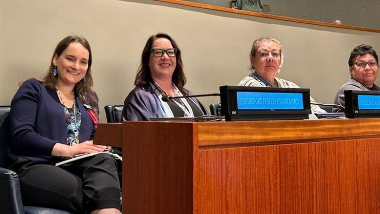  Alana Robert, Cora McGuire-Cyrette, Debra Vermette, and Lisa Echum sitting at the United Nations Permanent Forum on Indigenous Issues in New York City.