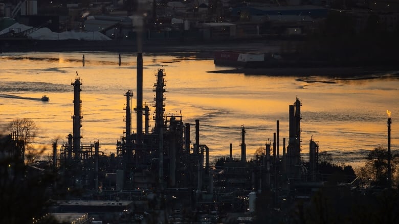 An activist investor wants Parkland Corp. to explore strategic alternatives for what it says are the company's non-core assets with the goal of becoming a more focused fuel and convenience store retailer.  A boat travels past the Parkland Burnaby Refinery on Burrard Inlet at sunset in Burnaby, B.C., on Saturday, April 17, 2021.