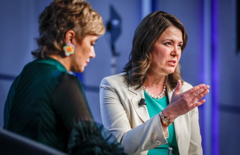 Two women chat on stage.