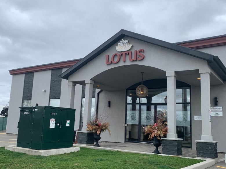 A sign with a lotus flower with the word 'Lotus' in large letters is placed on the front of the funeral home. 