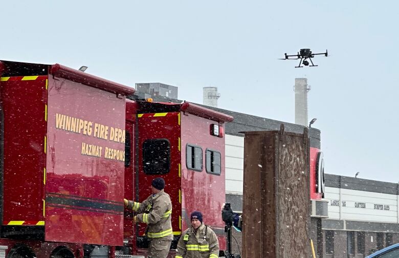 A drone lifts off next to a large red truck from the fire department.