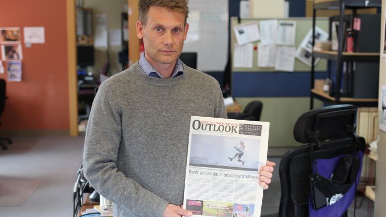 Jason Lyon, publisher of the Rocky Mountain Outlook, is pictured in the newspaper's office.