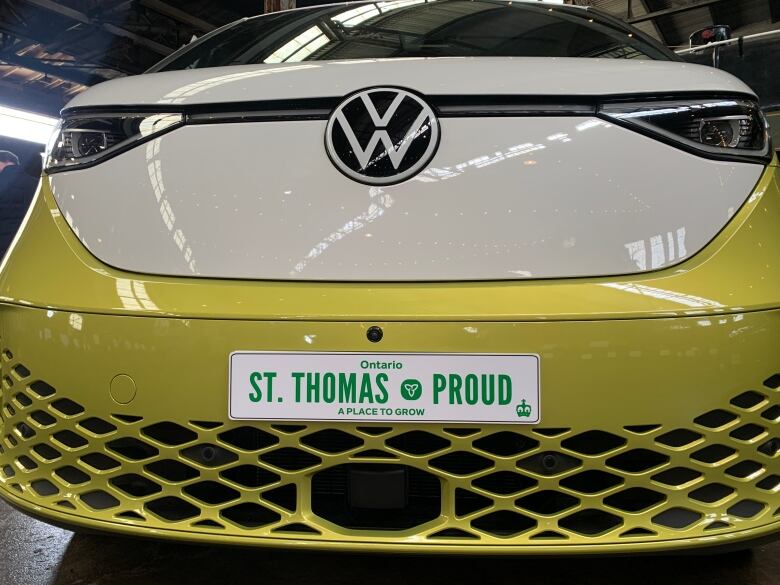 The bumper of a VW car with a license plate that reads St. Thomas Proud at an EV plant unveiling on April 23, 2023.