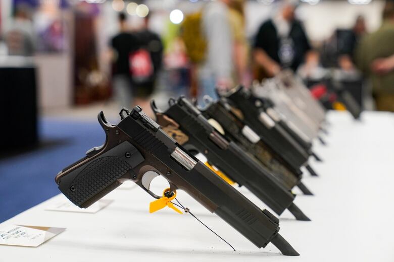 Pistols are displayed at an NRA event.