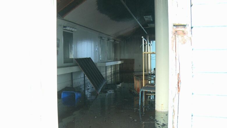 A flooded and burnt up room is pictured. 