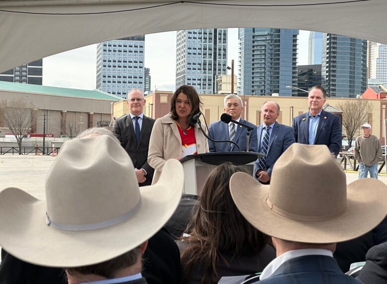 A woman speaks at a podium.