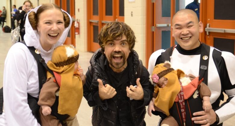 A family dressed up as Star Wars characters smiles.