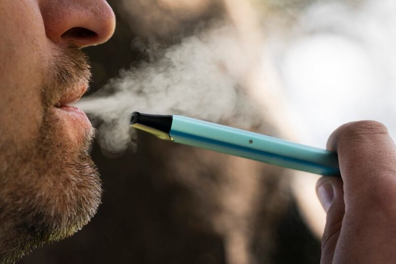 Generic image of vaping, vapers, smoke, nicotine, vaping, electronic cigarette. See close up of man smoking and exhaled smoke, side view, taken in downtown Montreal, QC on 20 Apr 2023.