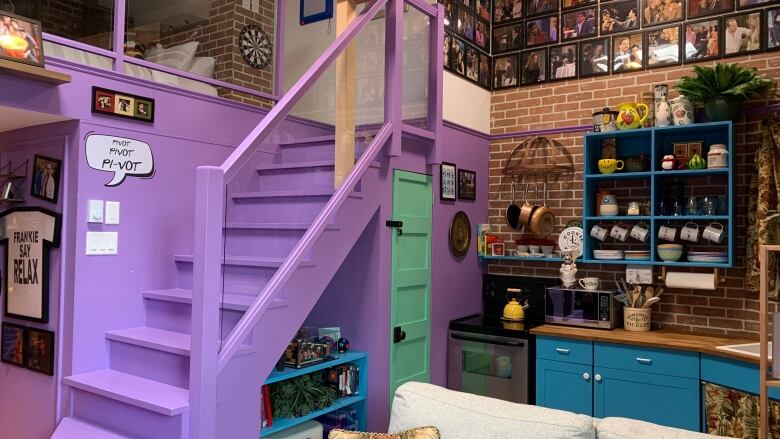 Brick and purple walls with teal cabinets to make a condo look like Monica's apartment in Friends