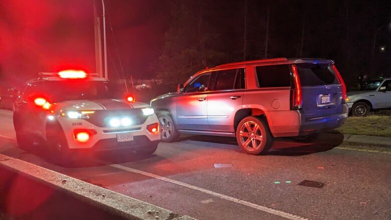 A police car and SUV on a highway.