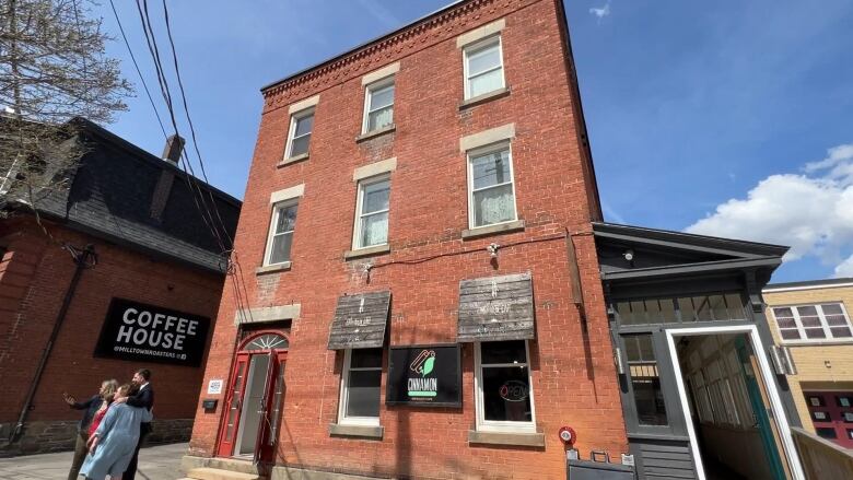 A three story red brick building.