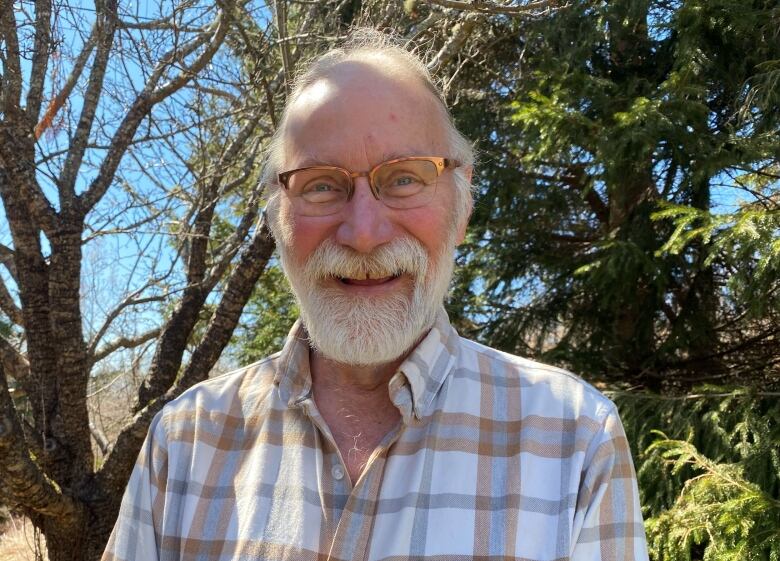 Gary Schneider, with trees in background.