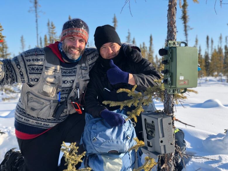 Two men smiling