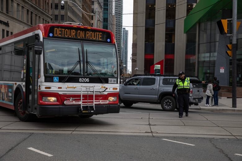 Drivers and transit riders in downtown Toronto navigate a roadway closure on Queen Street between Bay and Victoria streets for the next four-and-a-half years to accommodate construction of the Ontario Line's future Queen Station. Picture taken on May 1, 2023.