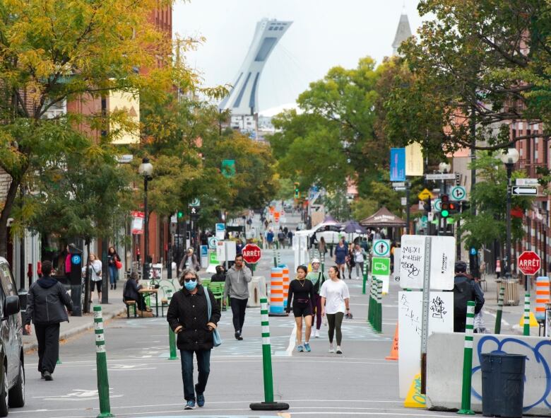 People are walking in the street. 