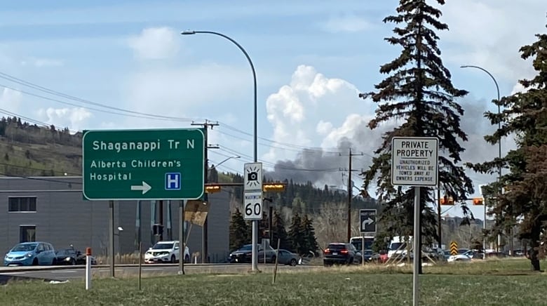 A cloud of smoke rises from the neighbourhood behind Winsport.