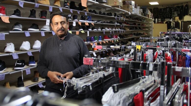 A man is pictured in a clothing store.