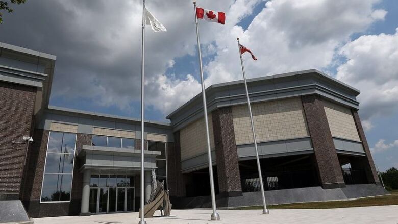 A brick building with flags out front