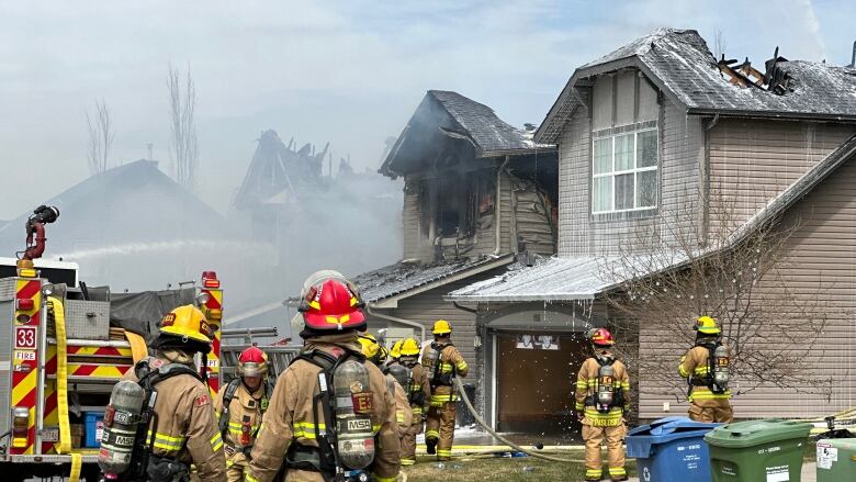 a roof and homes on fire