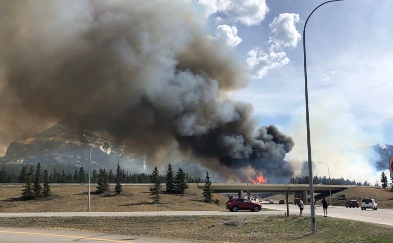 a highway with smoke and fire visible in the vicinity