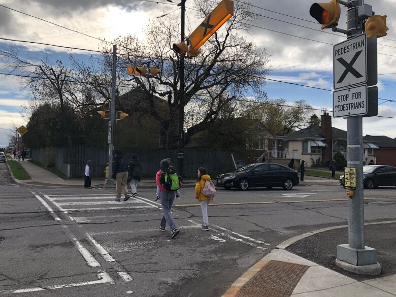 Families cross Caledonia rd