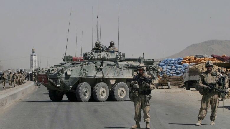 A Canadian armored vehicle with the International Security Assistance Force (ISAF) blocks the road at the site of a suicide attack in the city of Kandahar, south of Kabul, Afghanistan, on Thursday, Sept. 11, 2008.