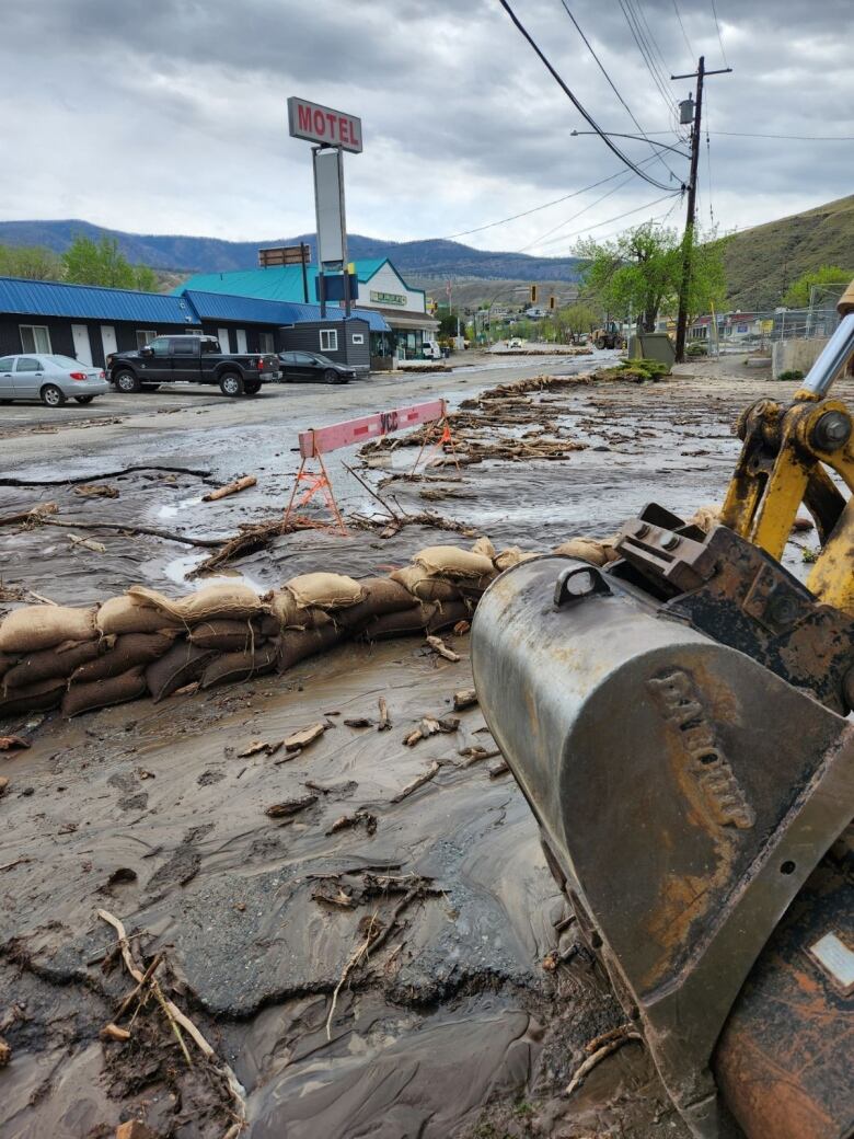 A washed out street with debris and sandbags due to flooding in Cache Creek B.C.