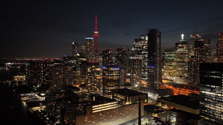 The Toronto skyline lit up at night as seen by a drone.