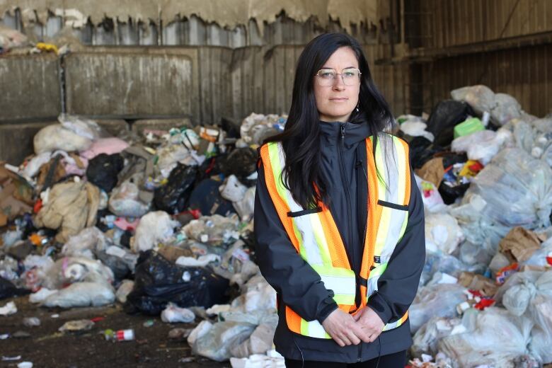 Carla Bitz, environmental coordinator with the Town of Banff, is pictured in front of a pile of garbage on the tipping floor at the town's waste transfer station.