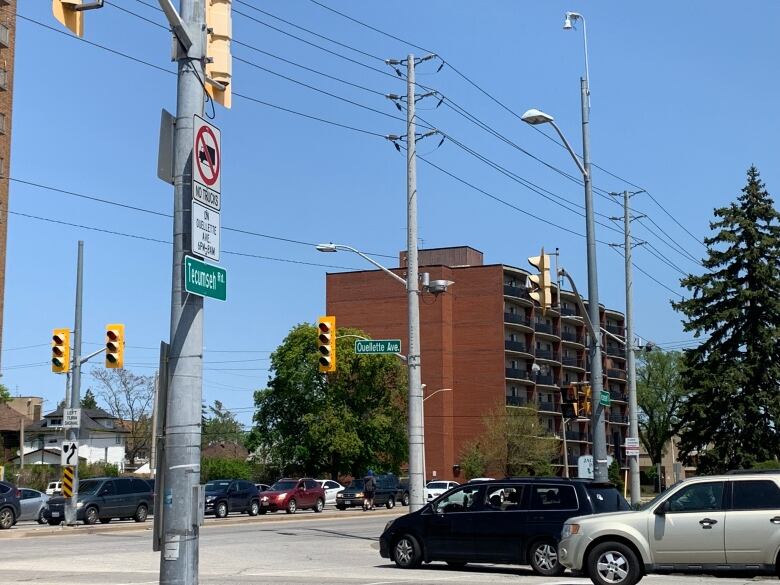 Cars stop at a red light at the intersection of Tecumseh Road and Ouellette Avenue. 