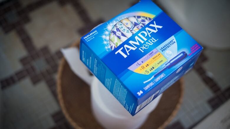 A box of Tampax tampons is shown.