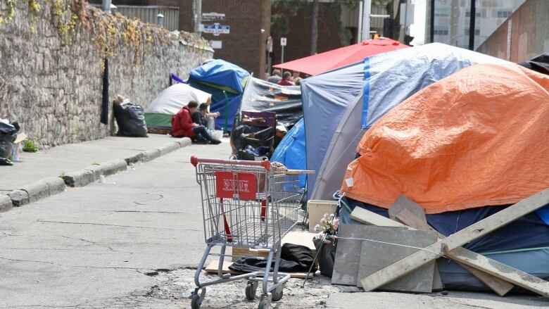 tents and a shopping cart on a road