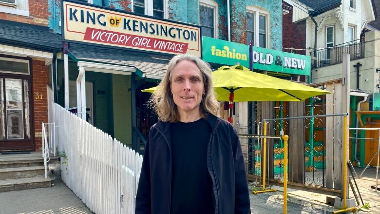 Kevin Barrett, co-chair of the Kensington Market Community Land Trust, says the group is trying to ensure people who live at the properties behind him have secure tenure and affordable rents.