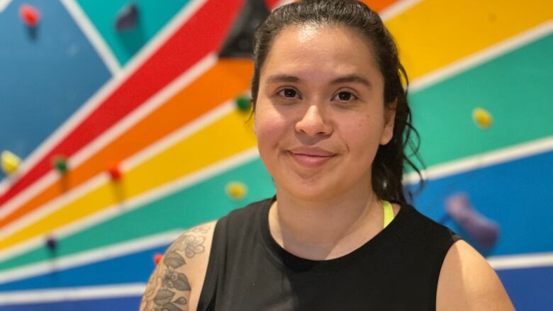 Coralia Sevilla is an avid climber, pictured in front of the new climbing wall.