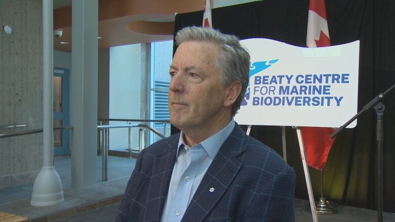 A man stands in front of a sign that reads Beaty Centre for Marine Biodiversity.