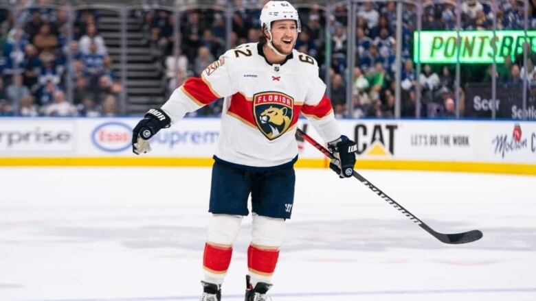 A hockey player smiles on the ice. 