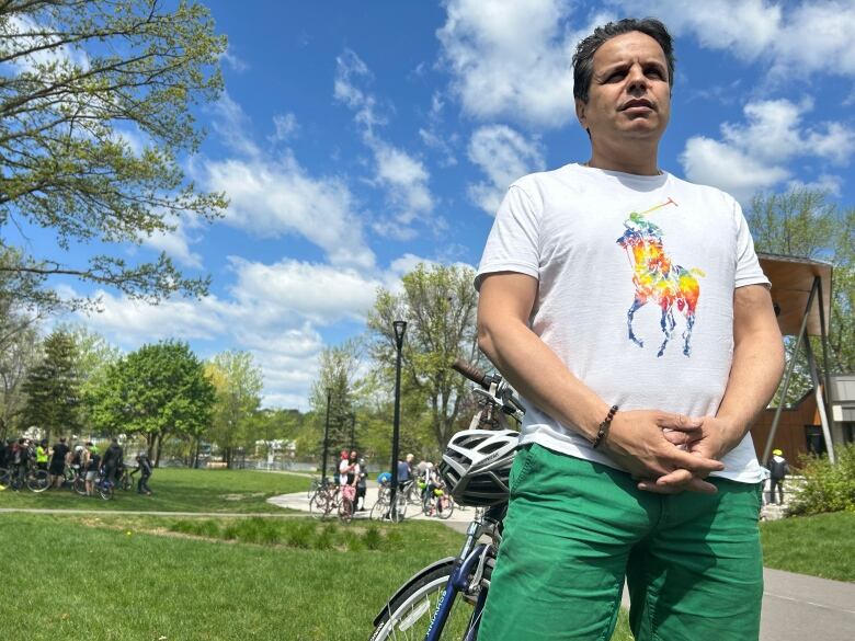 A man outdoors with a bike. 