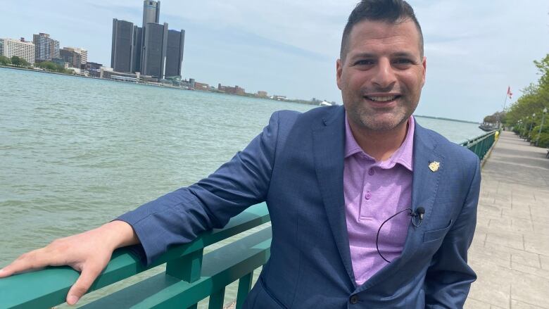 Fred Francis standing along the railing at the Detroit River.